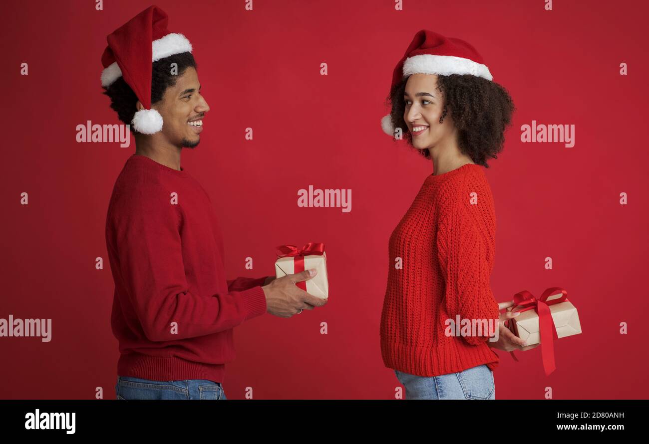 Couple in love exchanging New Year presents Stock Photo