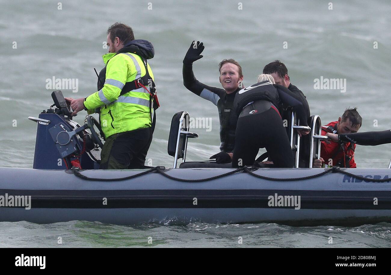 Former paratrooper John Bream (centre) waves to the press boat after setting the record for