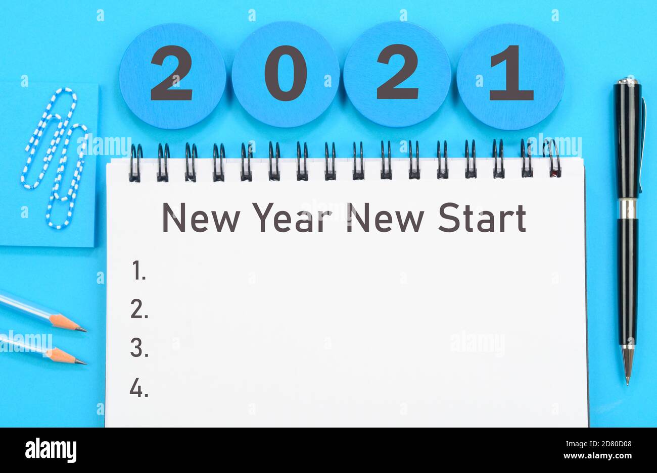 2021 New Year New Start written on a diary on blue background Stock Photo