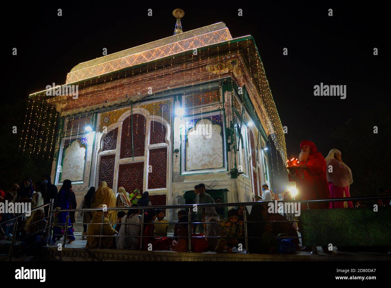 Lahore, Pakistan. 25th Oct, 2020. Pakistani Muslim devotees light candles and earthen lamps at