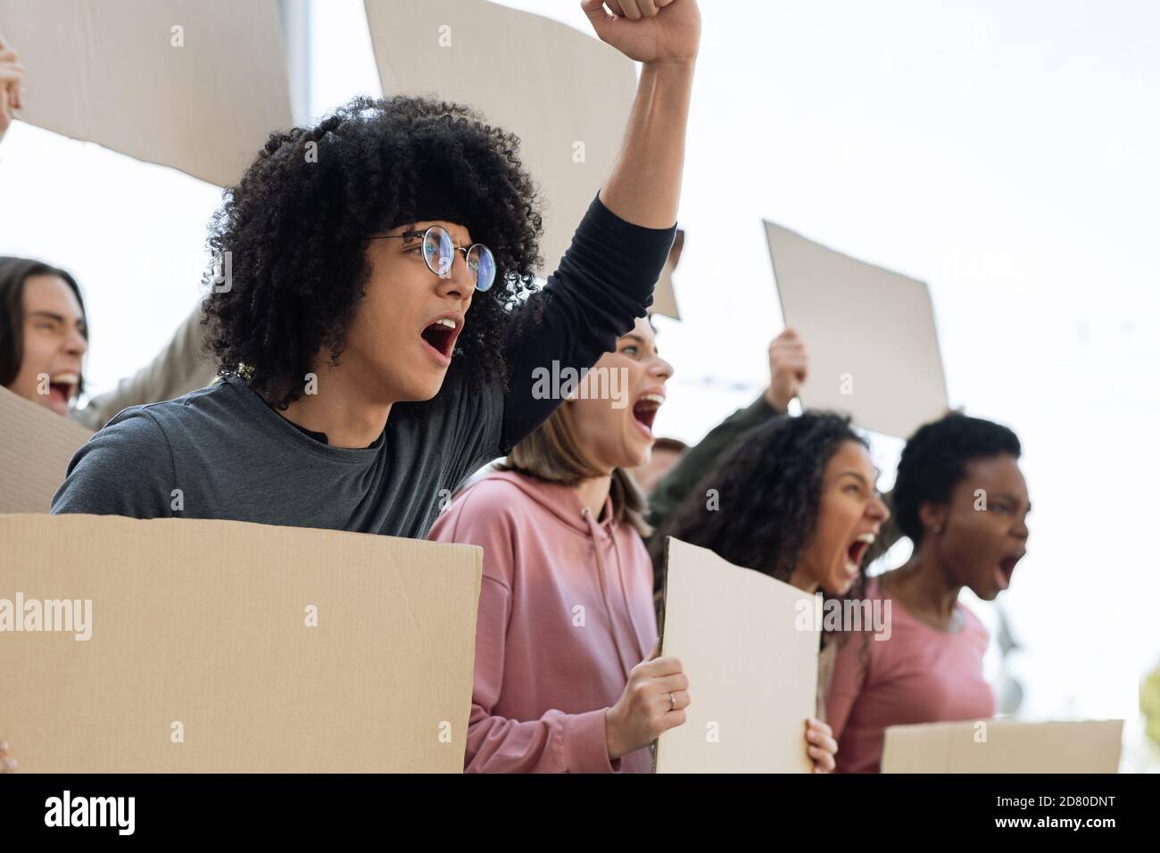 Side view of international group of strikers with blank placards Stock Photo