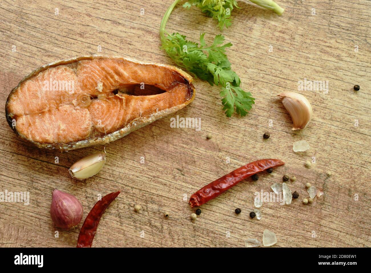 grilled salmon fish with salt and pepper on wooden background Stock Photo