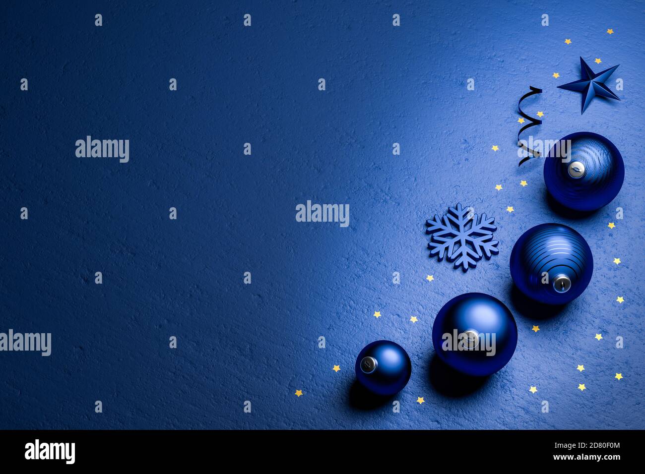 Classic Blue Christmas decoration on a classic blue stone background with small golden stars. Color of the year 2020. Copyspace Stock Photo