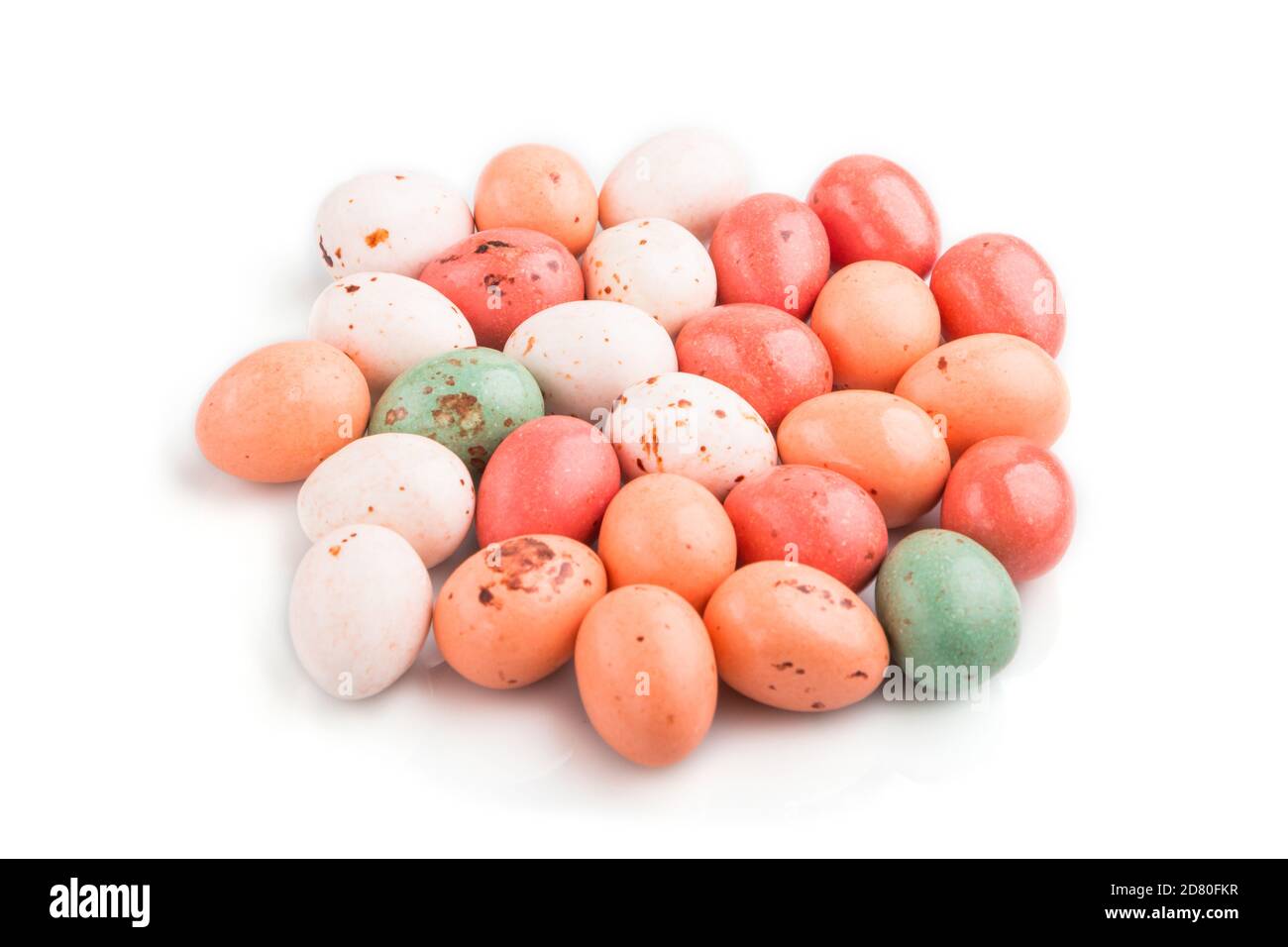 Pile of chocolate eggs candies isolated on white background. close up, side view, macro. Stock Photo
