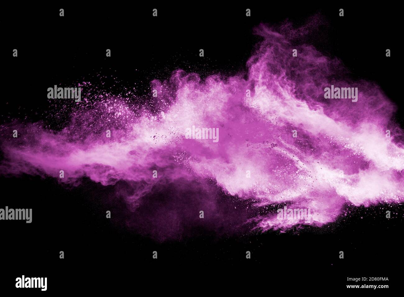 Abstract pink dust particles explosion on black background.Freeze motion of pink powder splash
