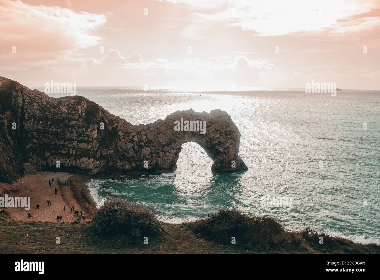 this is an image of the world famous Durdle Door on the Jurassic Coast, this was shot in the evening to get the bright and vibrant sunrise. Stock Photo