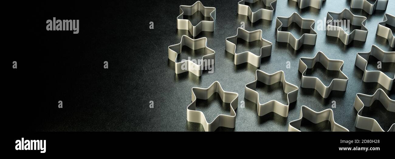 Christmas concept: Backlit star shaped cookie cutters on a countertop. Web banner. Stock Photo