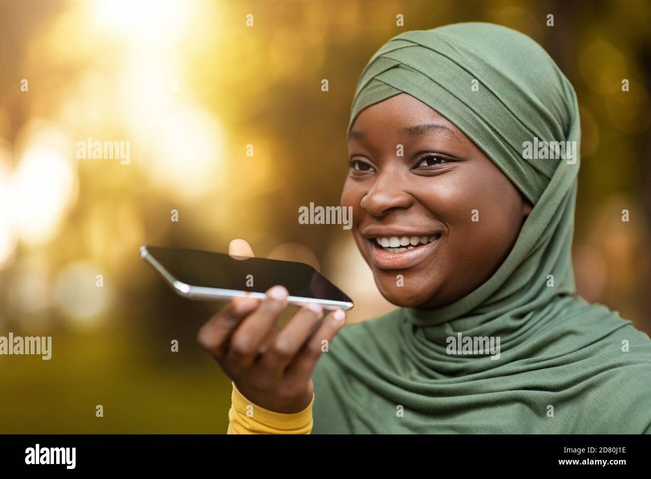Happy Black Muslim Woman In Hijab Recording Voice Message On Smartphone ...