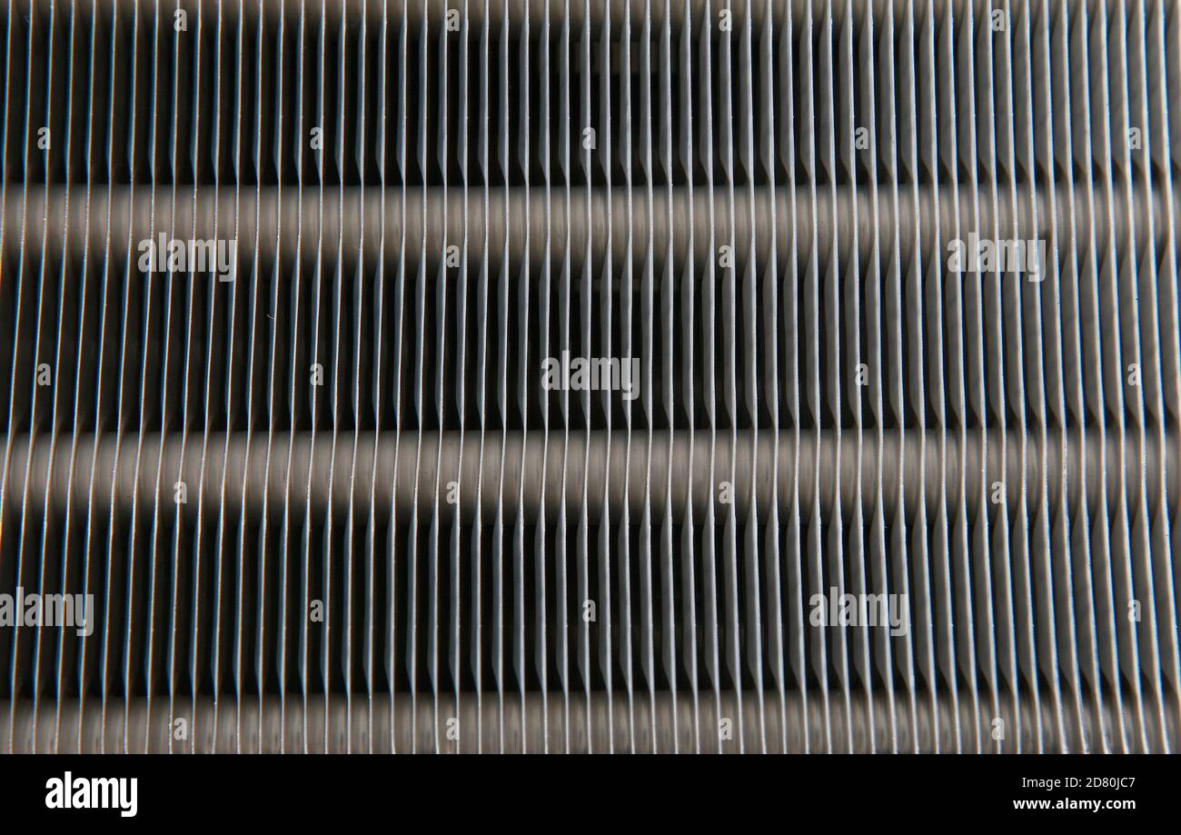 An air conditioner's evaporator coil, also called the evaporator core, is the part of the system where the refrigerant absorbs heat. Stock Photo