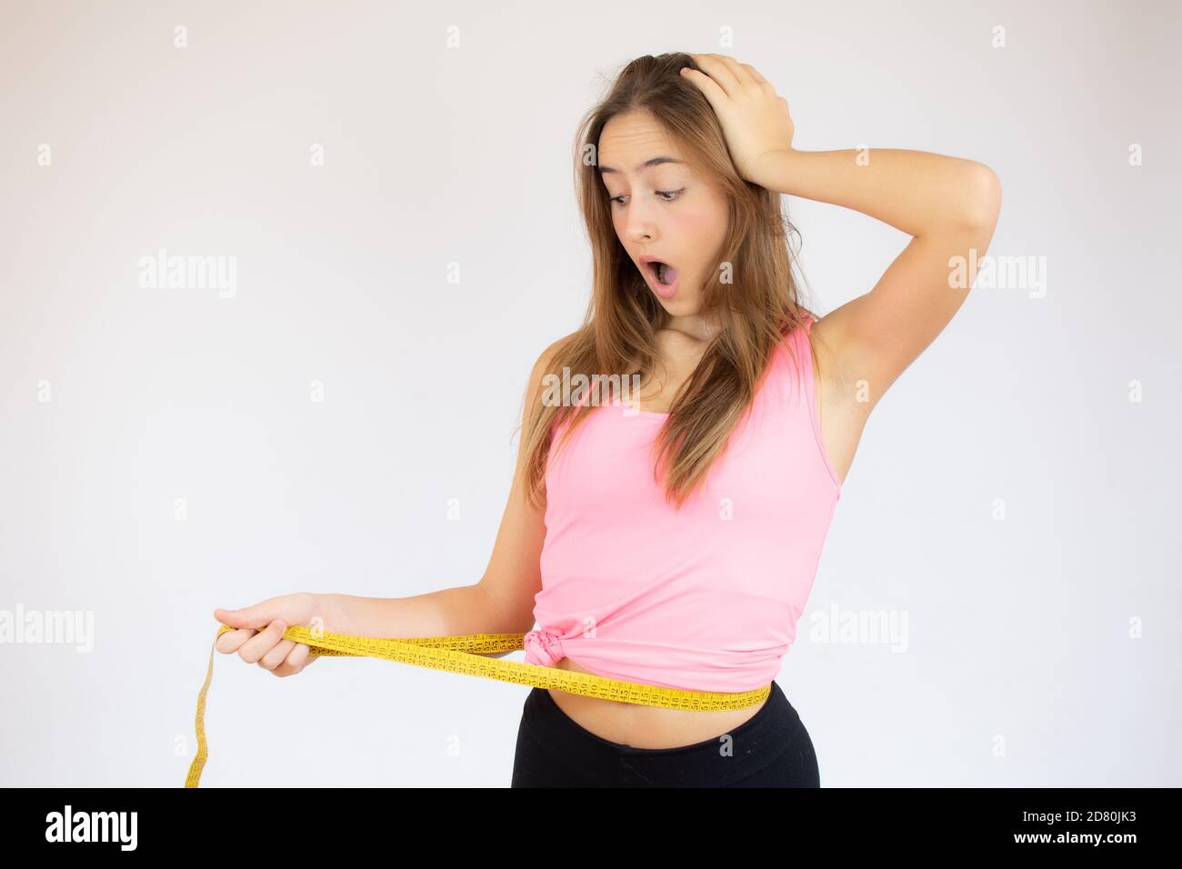 Woman Holds A Measuring Tape Around Her Waist Stock Photo, Picture and  Royalty Free Image. Image 140357555.