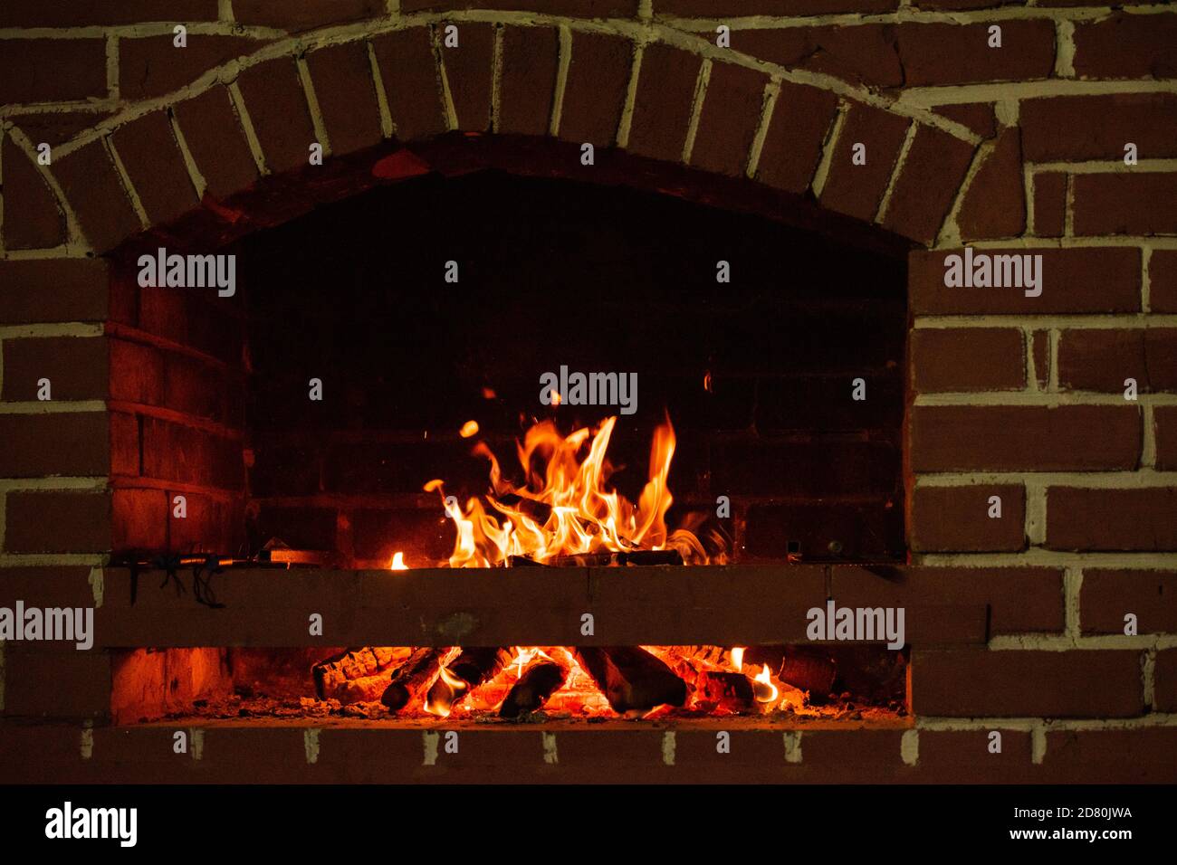 Fire in a fireplace. Wood burns in a cozy fireplace at home Stock Photo ...