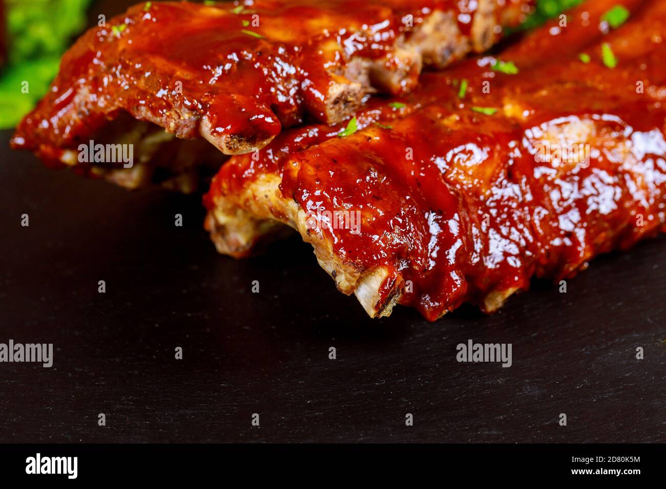 BBQ pork spare ribs on black background. Close up Stock Photo - Alamy