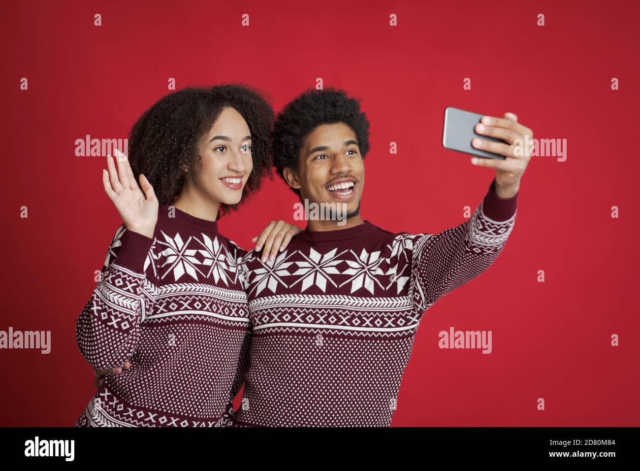 Joyful couple making video call to family or selfie at covid-19 Stock Photo