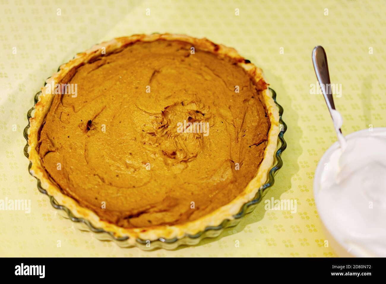 homemade rustic pumpkin pie on the table with whipped cream Stock Photo
