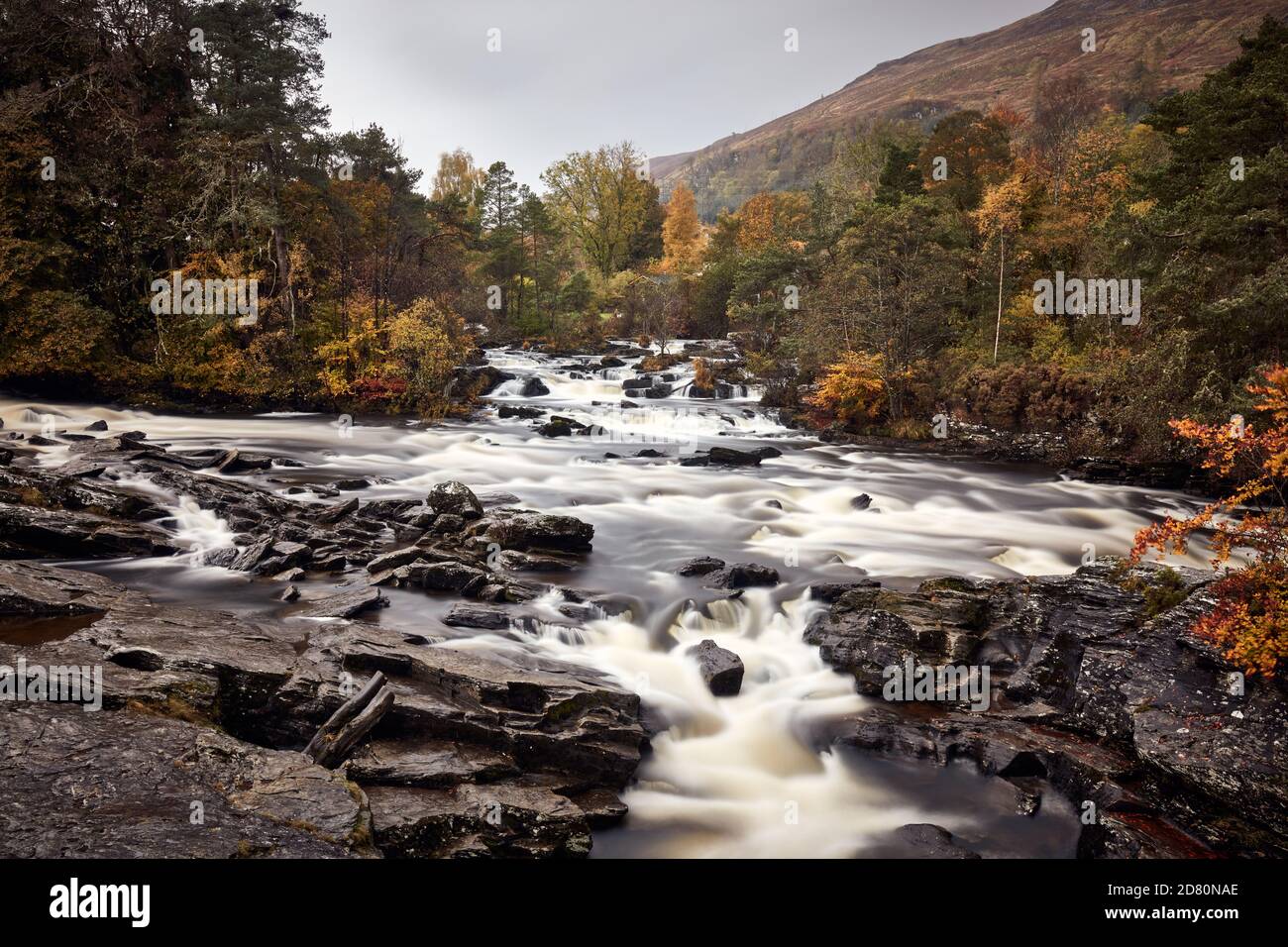 Autumnal colour at The Falls of Dochart in the village of Killin, Stirling Stock Photo
