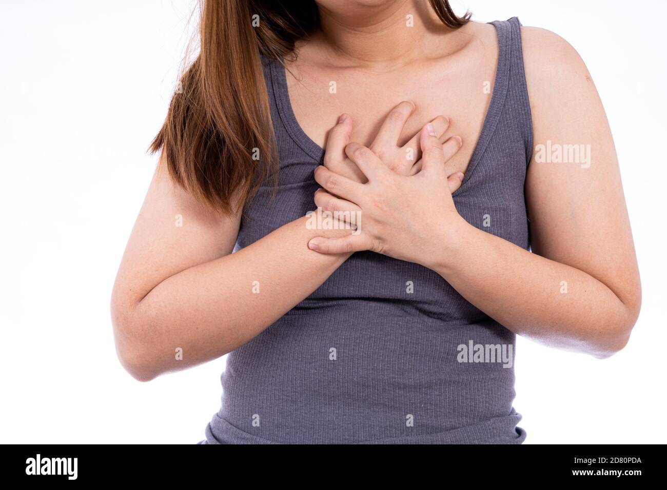 Woman touching her heart or chest isolated white background. Healthcare  medical or daily life concept Stock Photo - Alamy