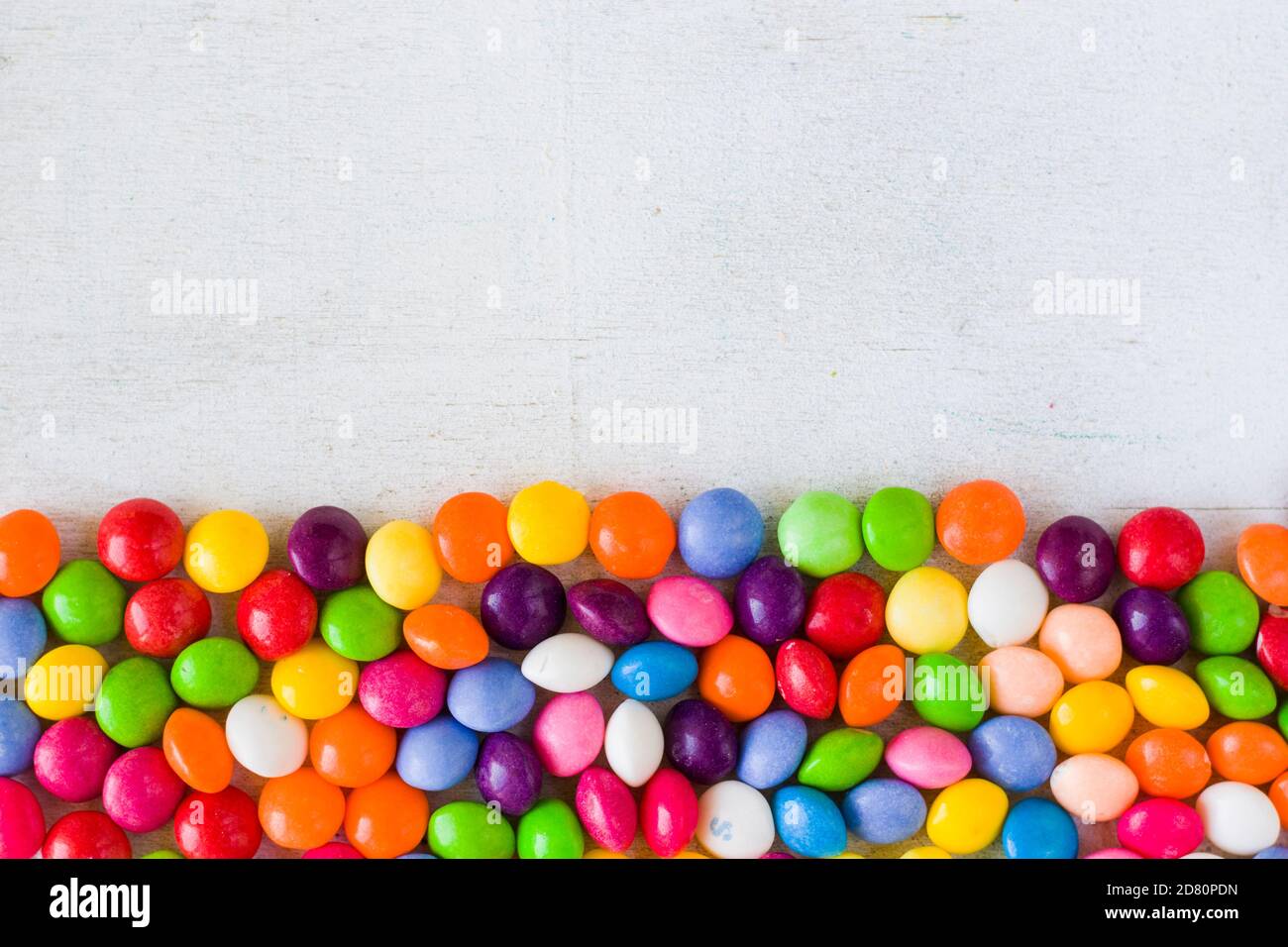 Skittles candy on the table, colorful sweet candy background Stock Photo -  Alamy