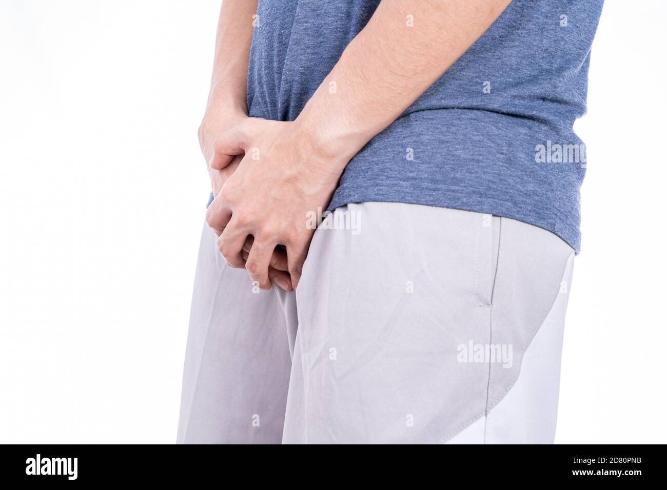 Man hands holding his crotch isolated white background. Medical, healthcare for advertising concept. Stock Photo