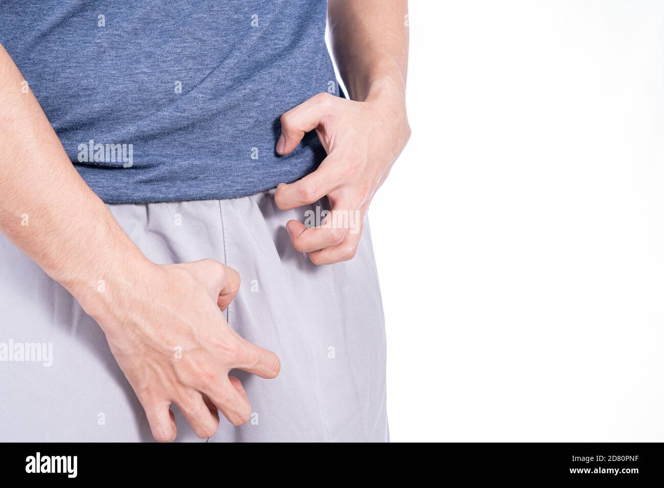 Man hands scratching his crotch isolated white background. Medical, healthcare for advertising concept. Stock Photo