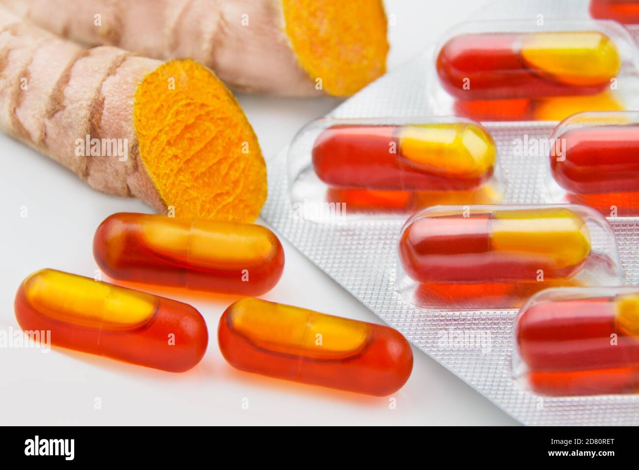 Curcuma capsules and root close up Stock Photo