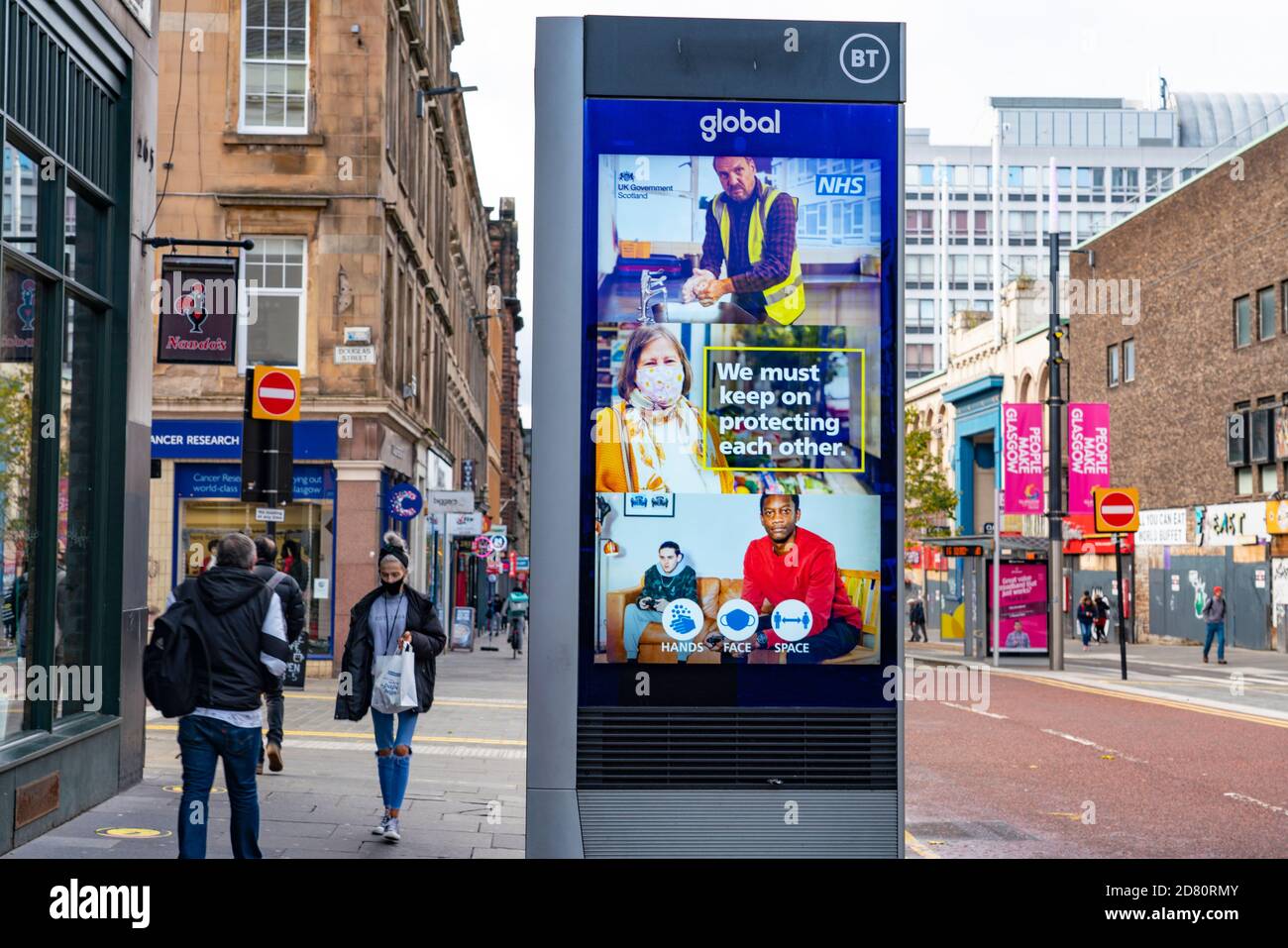 Glasgow, Scotland, UK. 26 October 2020. View of Glasgow city centre on weekday during circuit breaker lockdown with bars and restaurants closed. Pictured; Coronavirus advice on video screen on Sauchiehall Street . Iain Masterton/Alamy Live News Stock Photo