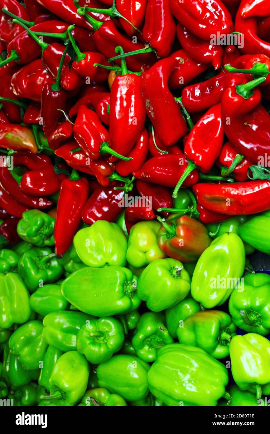 A collection of green and red peppers at a street market stall Stock ...