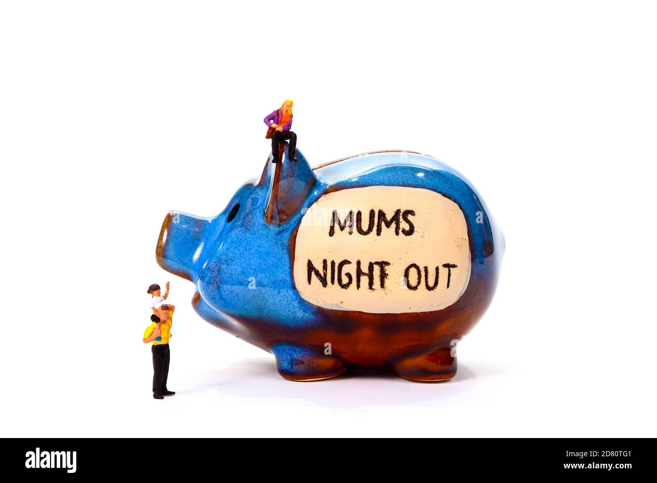Savings piggy bank with the words Mums Night Out and miniature figure woman man and child concept of saving up for a night out with friends Stock Photo