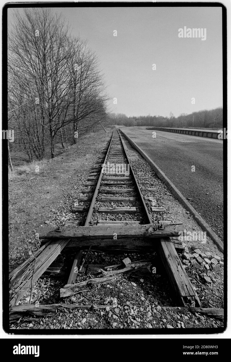 The remains of the Railway Line into Buchenwald . The Platform (seen here) is the beginning of the infamous Caracho Way (Carachoweg) which all prisoners had to use to walk to the camp. Caracho is a Spanish prison slang word for 'Double Time' and was so named by Spanish Communist prisoners who helped to build the railway and who were captured fighting against Franco in the Spanish Civil War.  Buchenwald; literally beech forest) was a Nazi concentration camp established on Ettersberg hill near Weimar, Germany, in July 1937. On the main gate, the motto Jedem das Seine (English: 'To each his own') Stock Photo