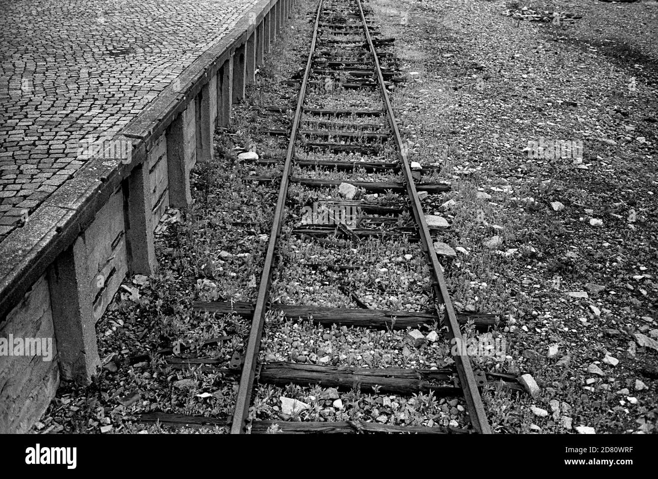 The remains of the Railway Line into Buchenwald . The Platform (seen here) is the beginning of the infamous Caracho Way (Carachoweg) which all prisoners had to use to walk to the camp. Caracho is a Spanish prison slang word for 'Double Time' and was so named by Spanish Communist prisoners who helped to build the railway and who were captured fighting against Franco in the Spanish Civil War.  Buchenwald; literally beech forest) was a Nazi concentration camp established on Ettersberg hill near Weimar, Germany, in July 1937. On the main gate, the motto Jedem das Seine (English: 'To each his own') Stock Photo