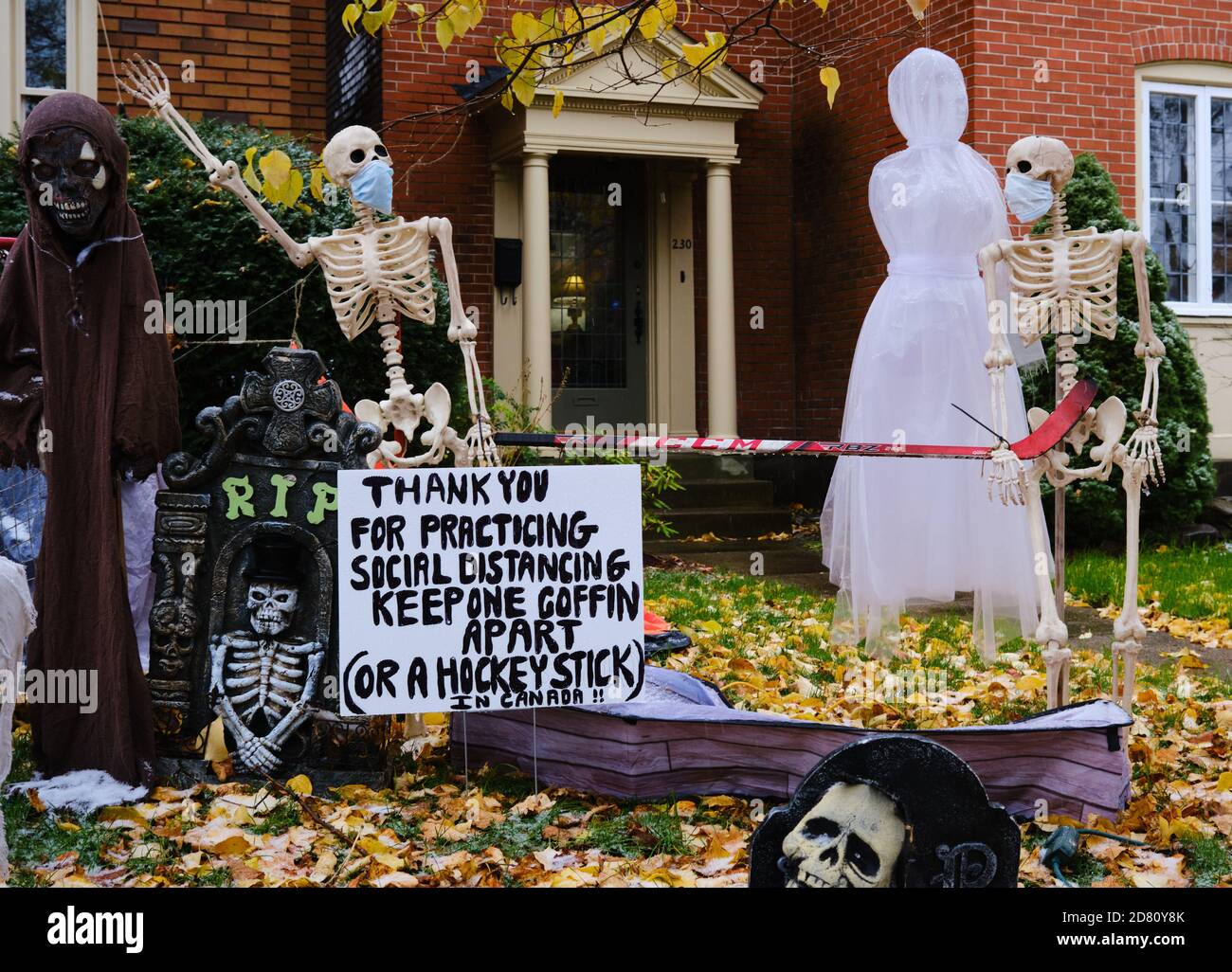 Ottawa, Canada. October 26th, 2020. Covid 19 themed Halloween decorations  set up at the front of a house in The Glebe. Skeleton wearing a mask, and  in Canadian fashion asking people to