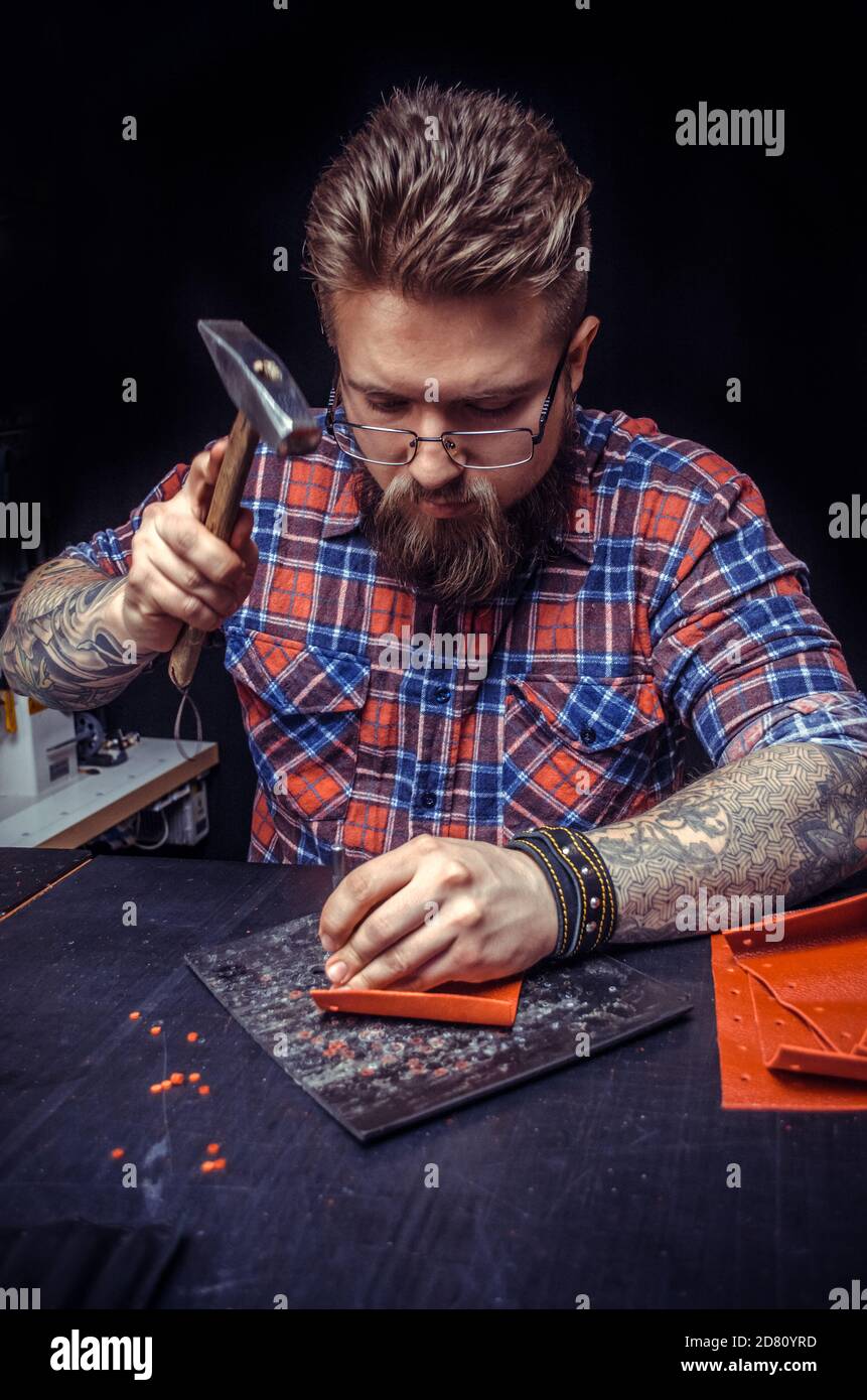 Craftsman working with leather working as artisan Stock Photo