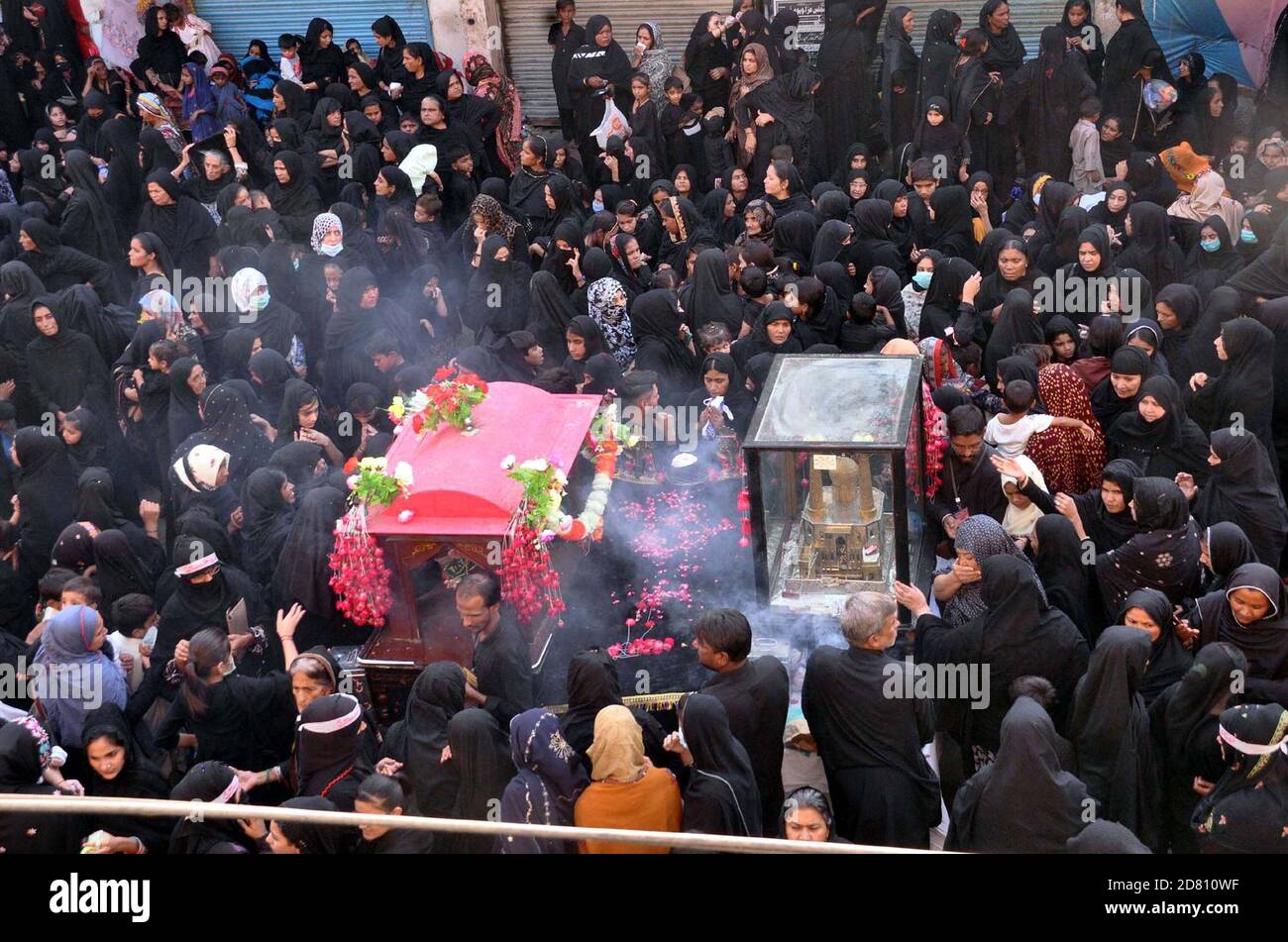 Shiite mourners are participating in procession of Chup- Tazia on the occasion of 8th Rabi-ul-Awwal every year to commemorate the death of Hazrat Imam Hasan al-Askari (A.S), in Hyderabad on Monday, October 26, 2020. Stock Photo