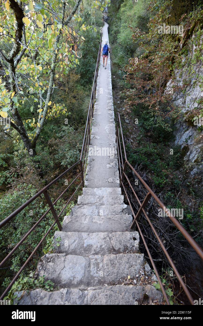 Walker Walking Along Raised Walkway or Footpath on the Lower Verdon Gorge, or Basses Gorges du Verdon, near Quinson Alpes-de-Haute-Provence France Stock Photo