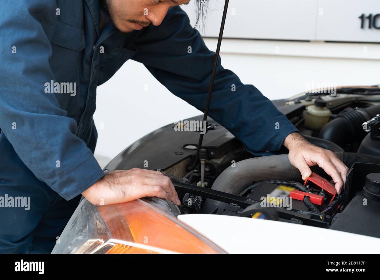 Professional mechanic providing car repair and maintenance service in auto garage. Car service business concept. Stock Photo