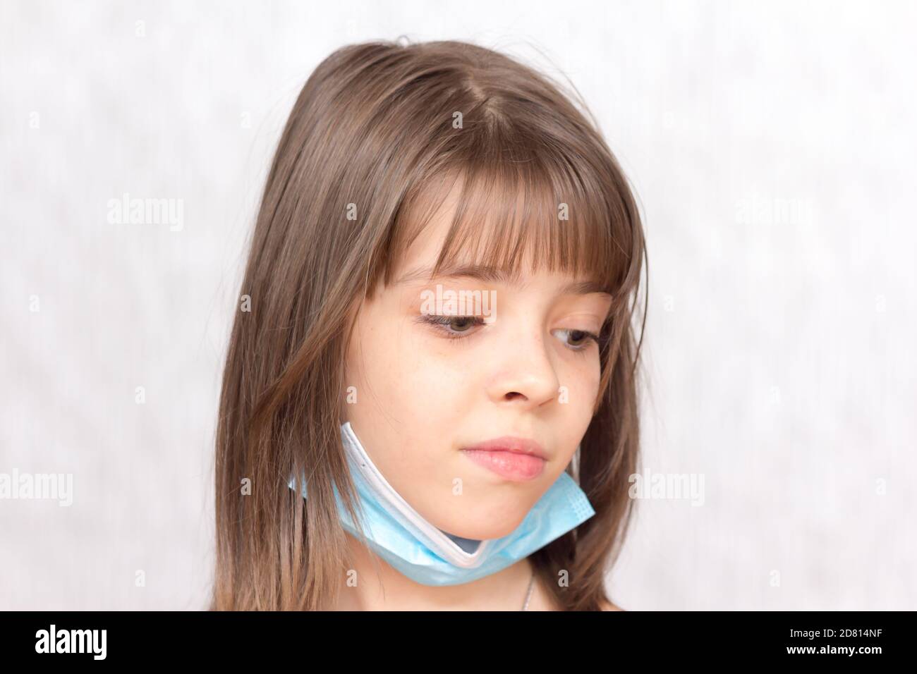 Portrait of a sad girl with a medical disposable mask on her face Stock ...