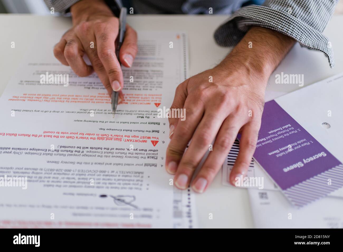 close up of man completing absentee ballot 2020 election Stock Photo