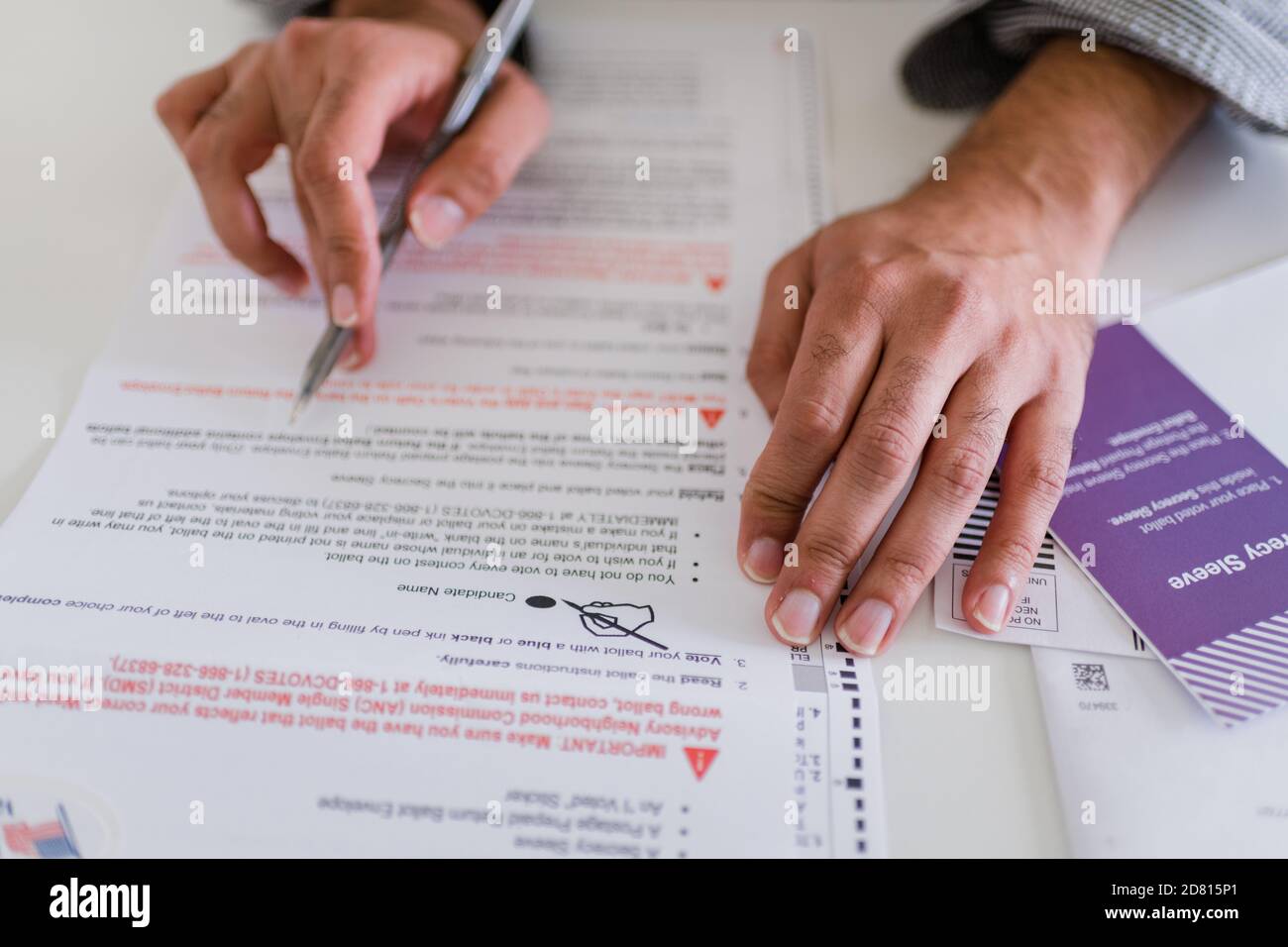 close up of hands completing absentee ballot Stock Photo