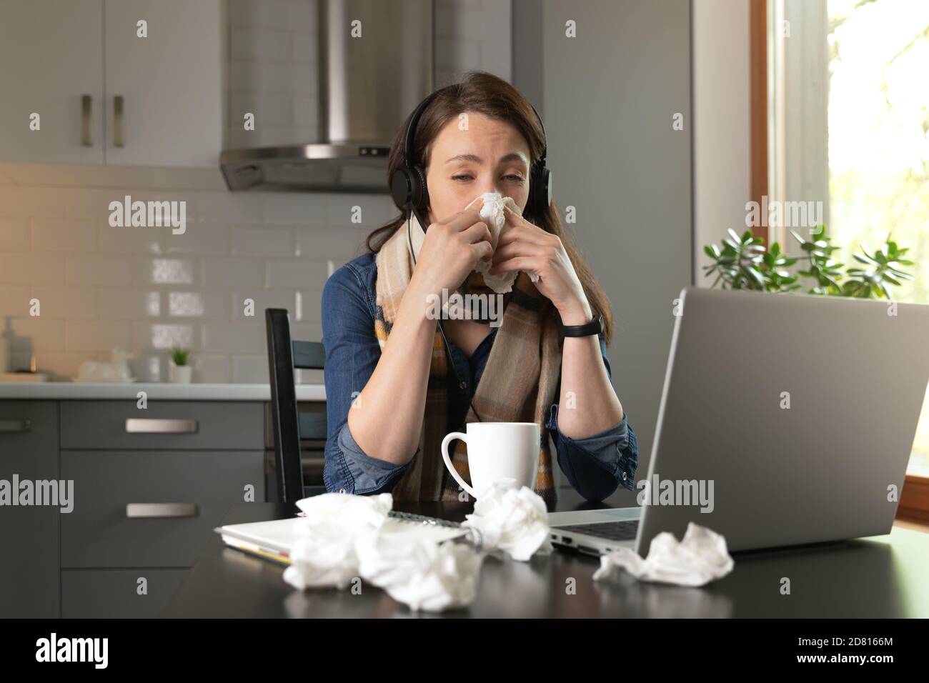 Beautiful women working from home while feeling sick. Stay at home. Stock Photo