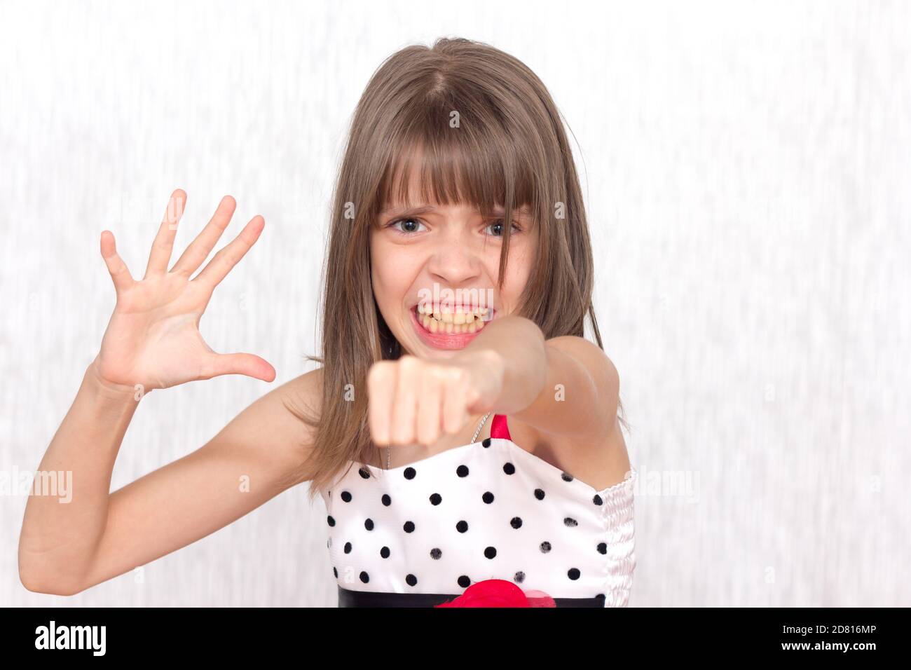 Angry Girl And Emotional Girl Clenched Her Hand Into A Fist Isolated On