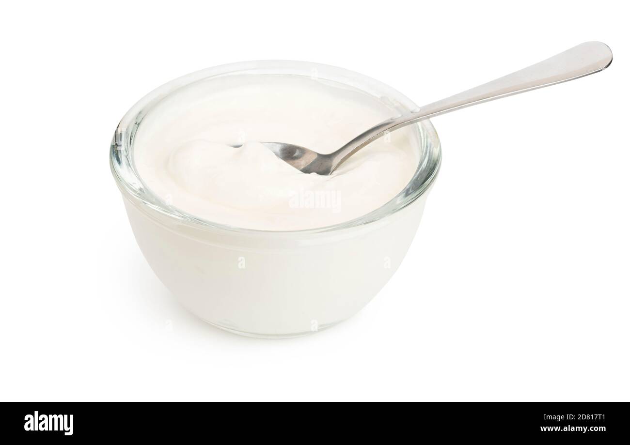 White yogurt in a glass bowl and spoon isolated with soft shadow Stock Photo