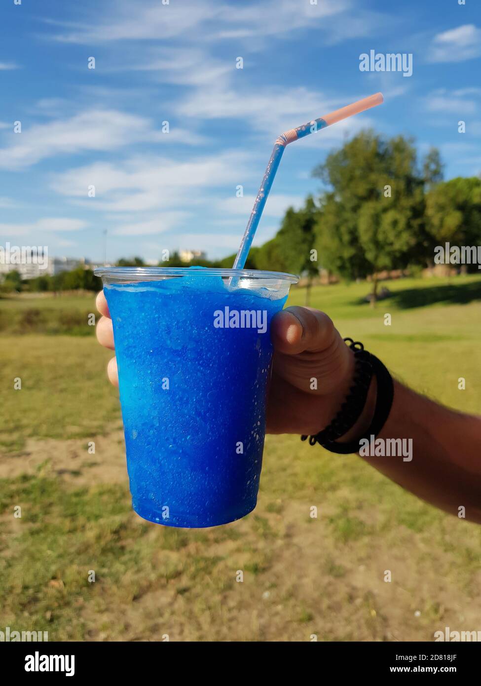 crushed ice drinks with straws in hands Stock Photo - Alamy