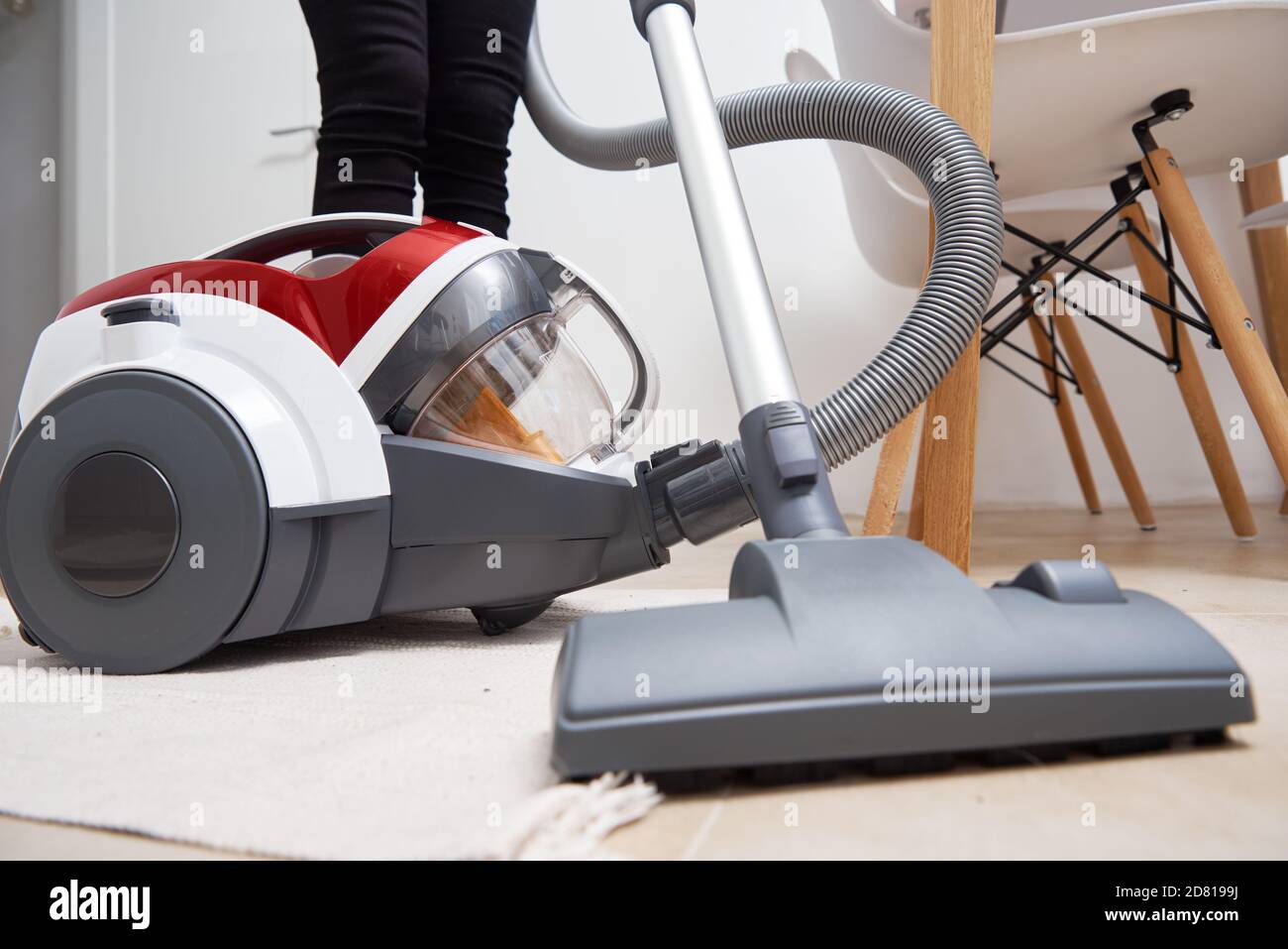 Woman using vacuum cleaner at the floor Stock Photo Alamy