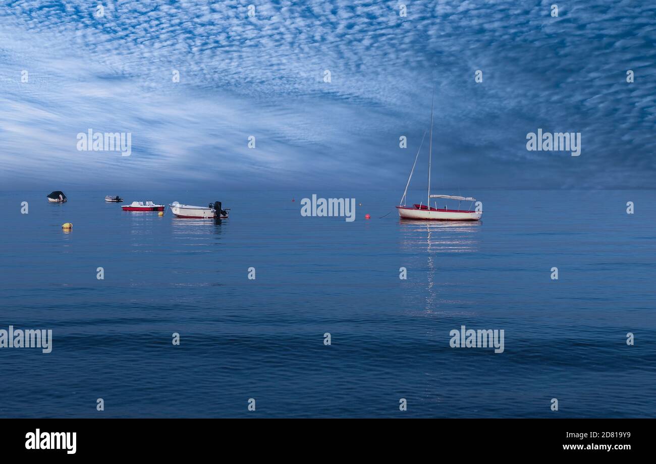 Various boats on the Baltic Sea, Germany. The sky and the sea merge. Stock Photo