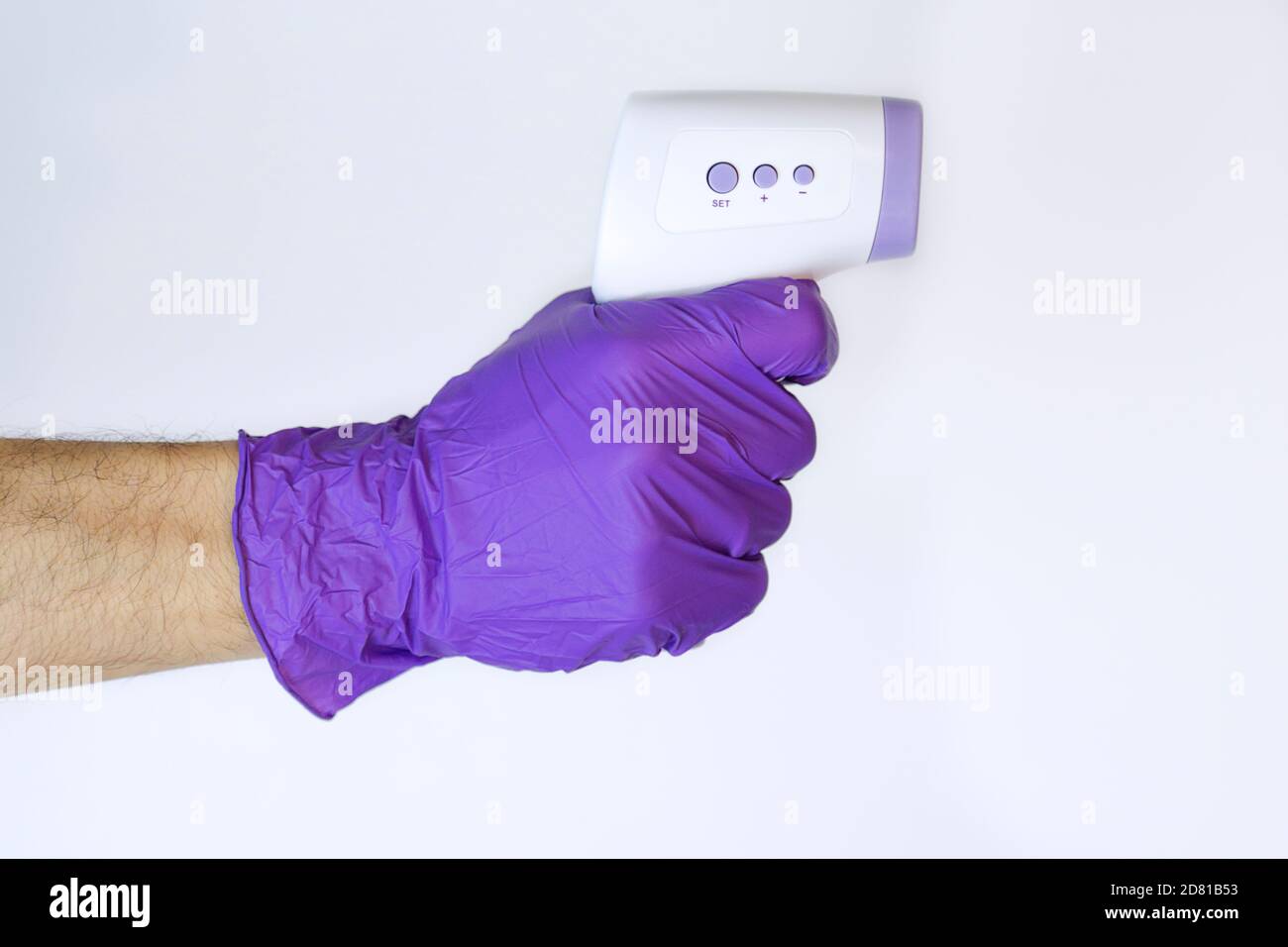 Man holding a digital thermometer to check body temperature Stock Photo Alamy