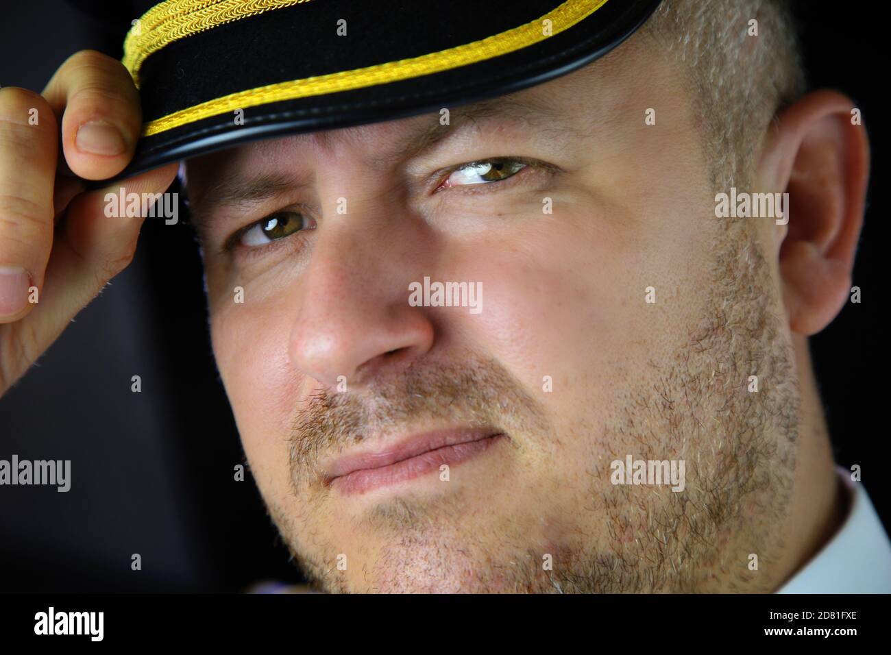 captain of the plane pilot in uniform with stubble Stock Photo