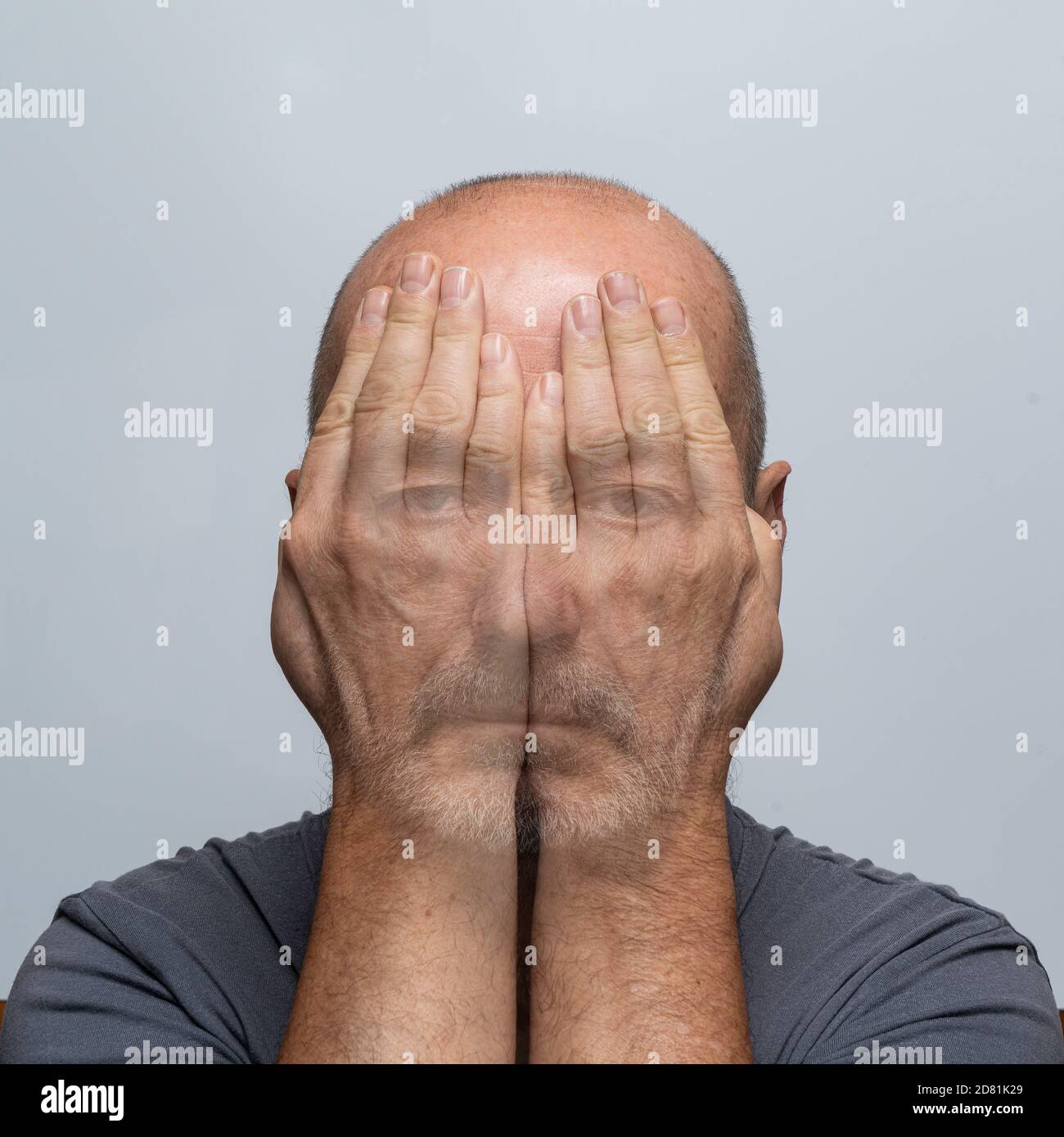 a man's gaze through his hands Stock Photo