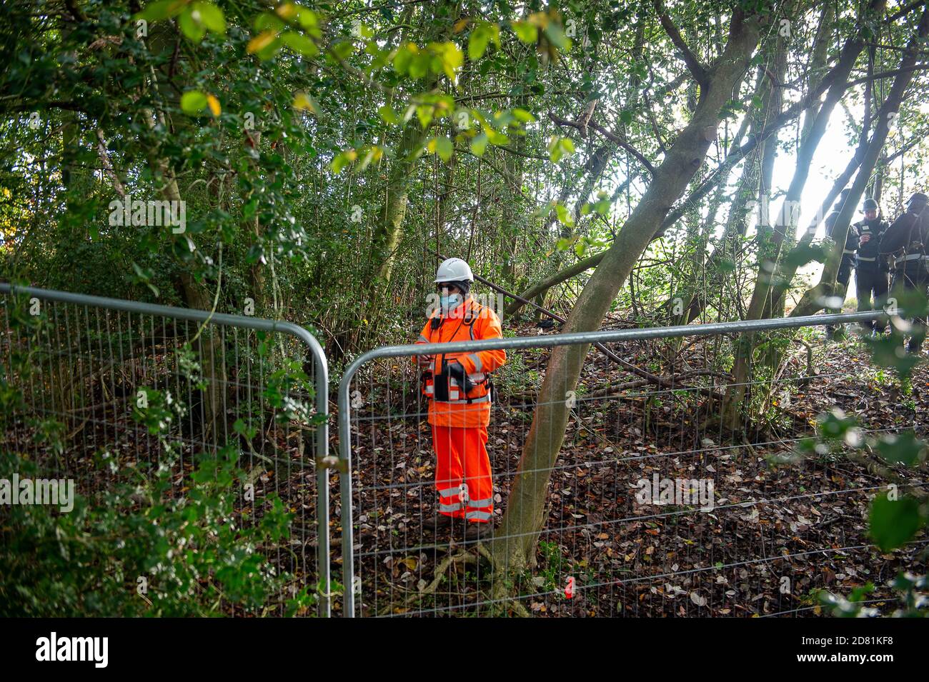Aylesbury Vale, Buckinghamshire, UK. 26th October, 2020. HS2 security guards in the woods. HS2 are continuing to fell ancient woodland at Grim's Ditch in Buckinghamshire this morning. Anti HS2 environmental campaigners allege that HS2 do not have a bat licence for felling in these ancient woodlands and so are potentially committing a wildlife crime. They have reported the matter to the Police again this morning an are awaiting a response. Construction of the High Speed Rail from London to Birmingham puts 108 ancient woodlands, 33 SSSIs and 693 wildlife sites at risk. Credit: Maureen McLean/Ala Stock Photo