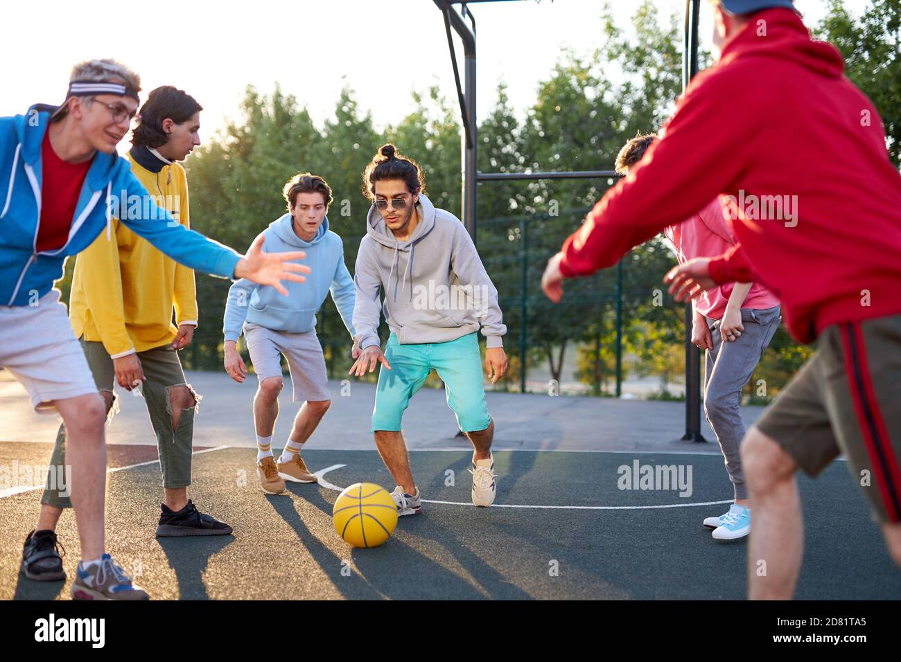 young caucasian boys have fantastic active basketball game, handsome guys  in casual clothes gathered to hold competition Stock Photo - Alamy