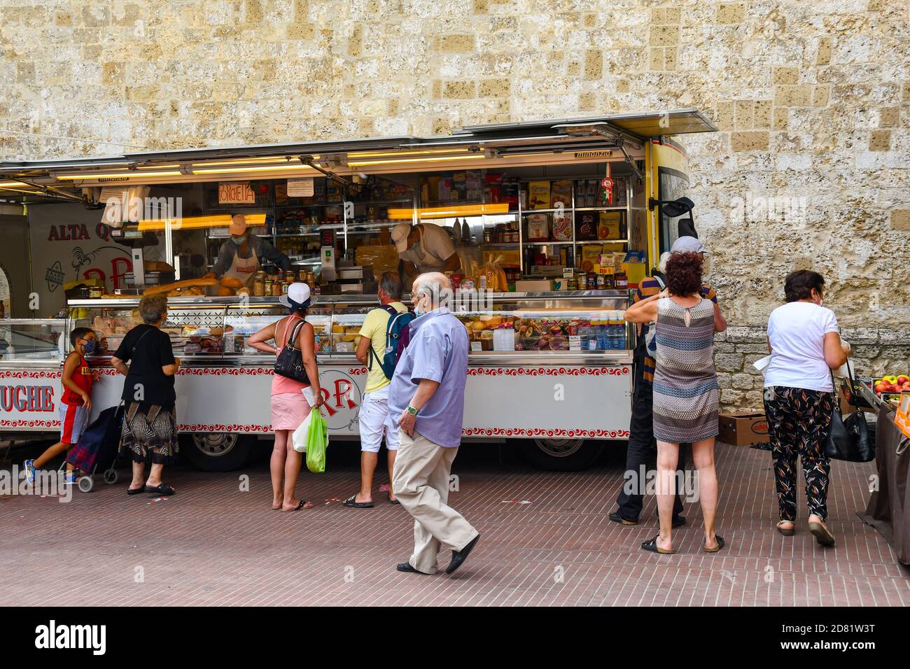 People shopping at a food market truck in the old town of San Gimignano, Unesco World Heritage Site, Siena, Tuscany, Italy Stock Photo