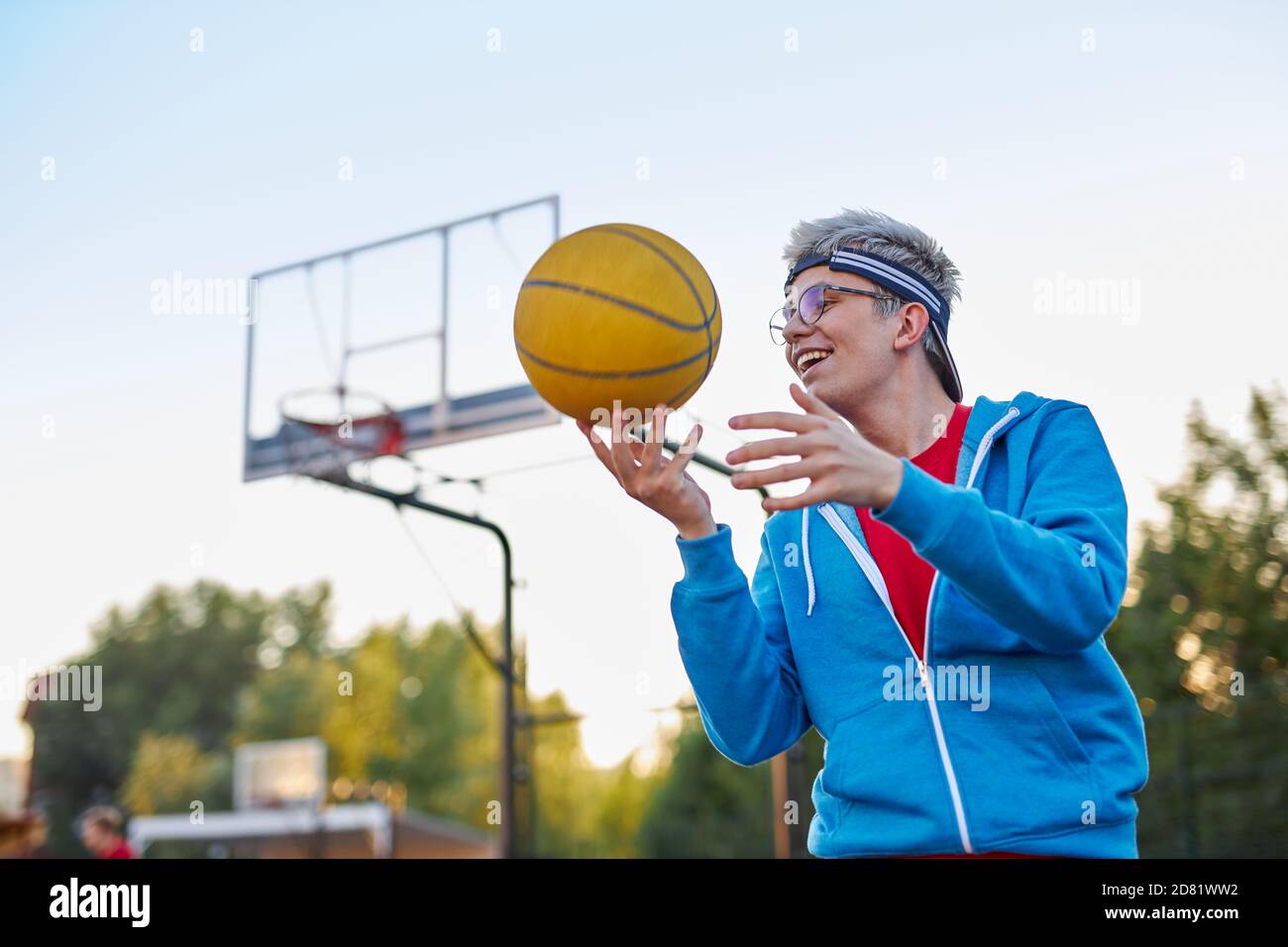 young teen boy's hobby is basketball, modern male in casual sportive wear preparing for competition Stock Photo